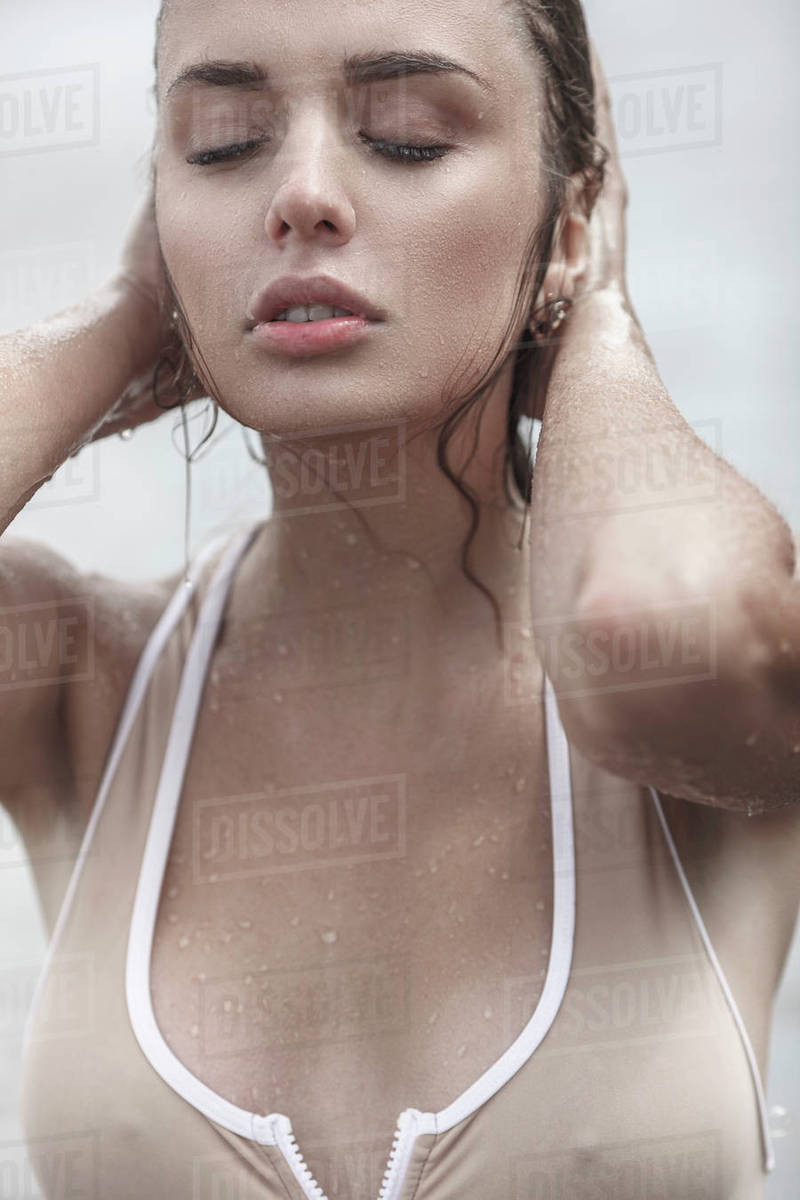 Close Up Of Sensuous Young Woman With Closed Eyes Touching Wet Hair Close Up Of Sensuous Young Woman With Closed Eyes Touching Wet Hair