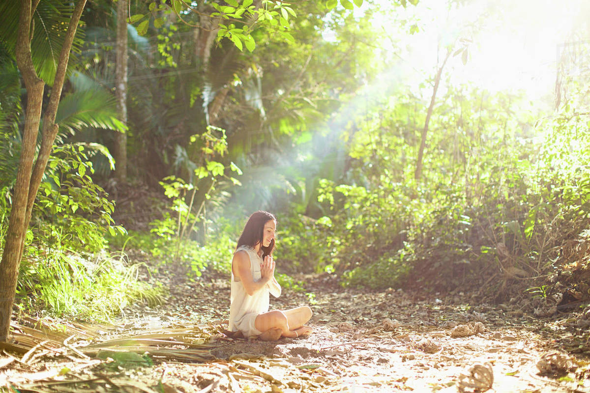 Serene woman meditating in sunny, tranquil woods, Sayulita, Nayarit, Mexico Royalty-free stock photo