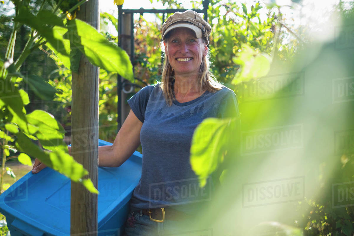 Portrait confident smiling farmer in sunny vegetable garden Royalty-free stock photo