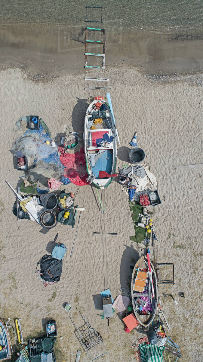 View from above fishing boats and equipment strewn on beach Royalty-free stock photo