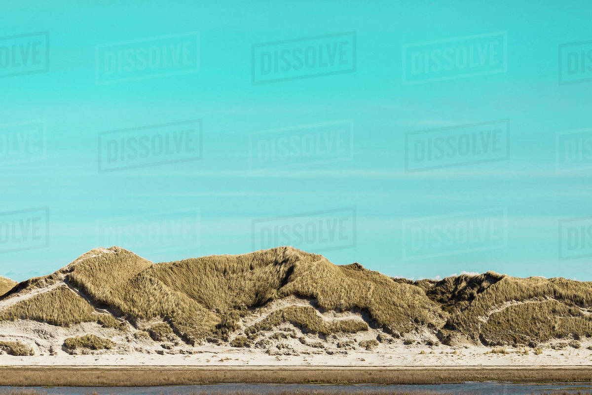 Tranquil sand dunes under sunny blue sky, Norddorf, Schleswig Holstein, Germany Royalty-free stock photo