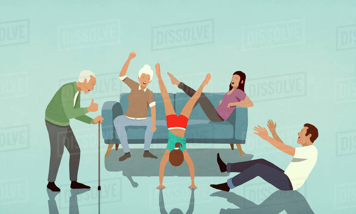 Happy multi-generation family cheering for girl doing handstand in living room Royalty-free stock photo