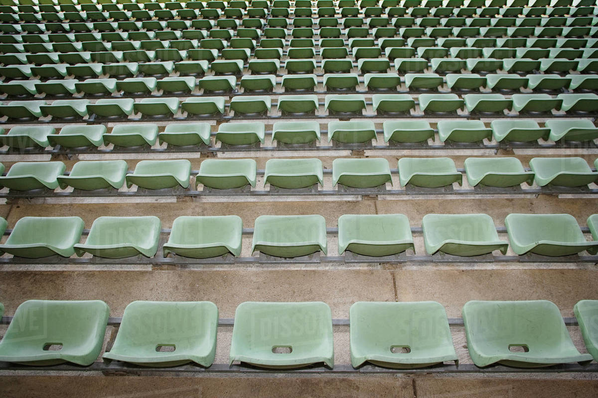 Rows of green seats in stadium Stock Photo Dissolve